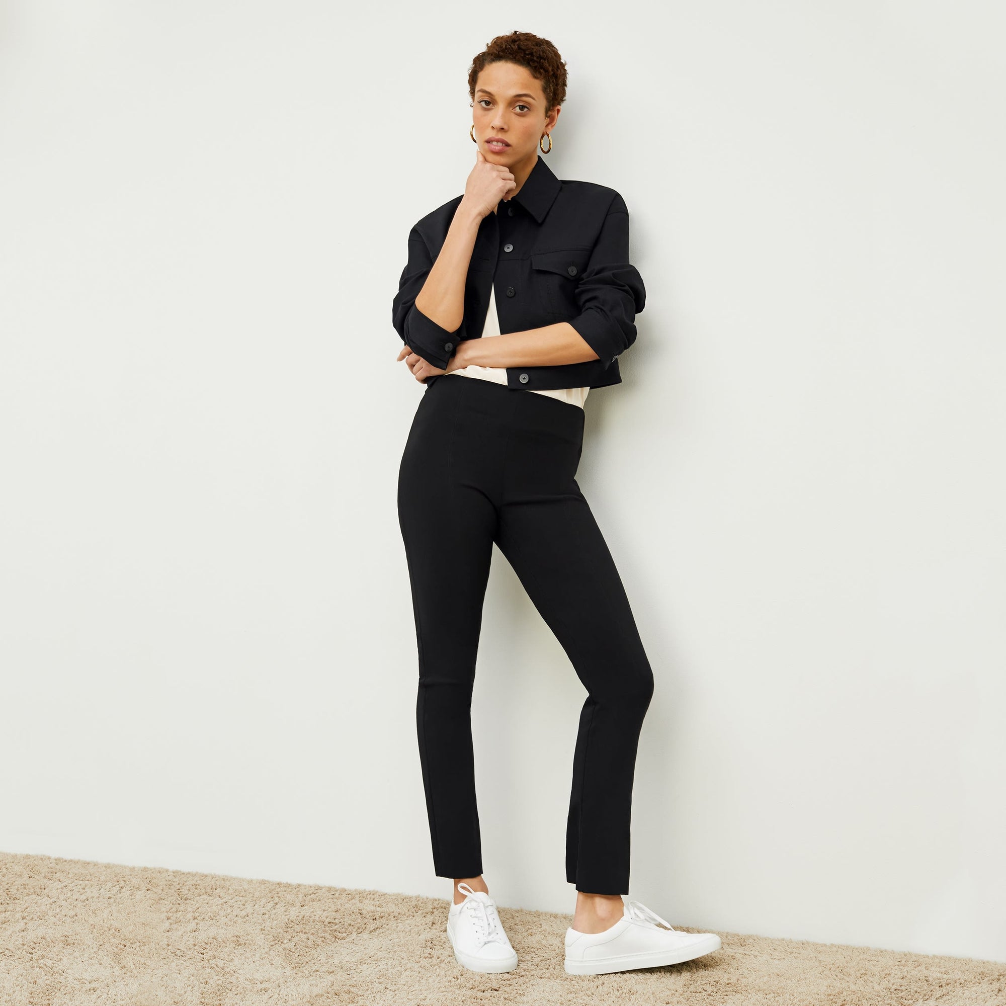Front image of a woman standing wearing the Foster Pant—Everstretch in Black | Exclude
