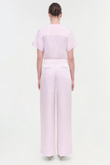 Light pink wide-leg pant with high waist and back pocket detail, shown on model from behind.