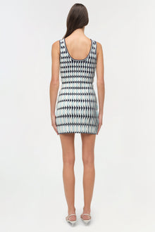 Sleeveless knit mini dress with black and white geometric arrow pattern and scalloped edges, shown from back.