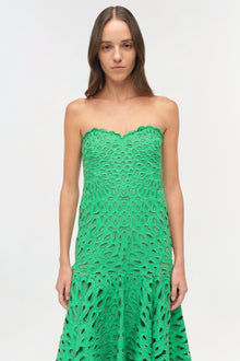 Green strapless midi dress with allover cutout embroidered pattern and scalloped neckline.