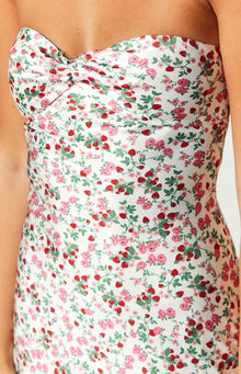 Close-up of the white dress bodice with a twisted sweetheart neckline and pink rose and red strawberry print
