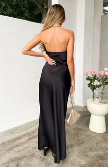 Rear view of a black strapless maxi dress with a straight-across back and a flowing skirt