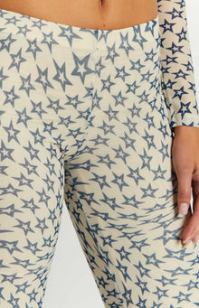 Close-up of the sheer cream mesh pants with a dense blue star print and visible seam
