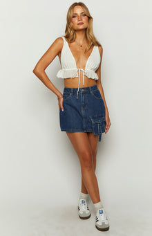 Dark wash denim mini skirt with a cargo pocket detail on the right side and a fitted A-line cut