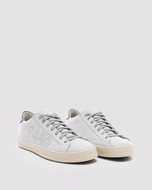 Side angle of white and  green sneakers