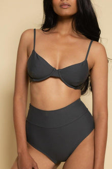 Charcoal high-rise bikini bottom with full coverage waistband on model against neutral background.