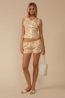 Sleeveless vest with orange cherry print and scalloped edges, paired with matching shorts.