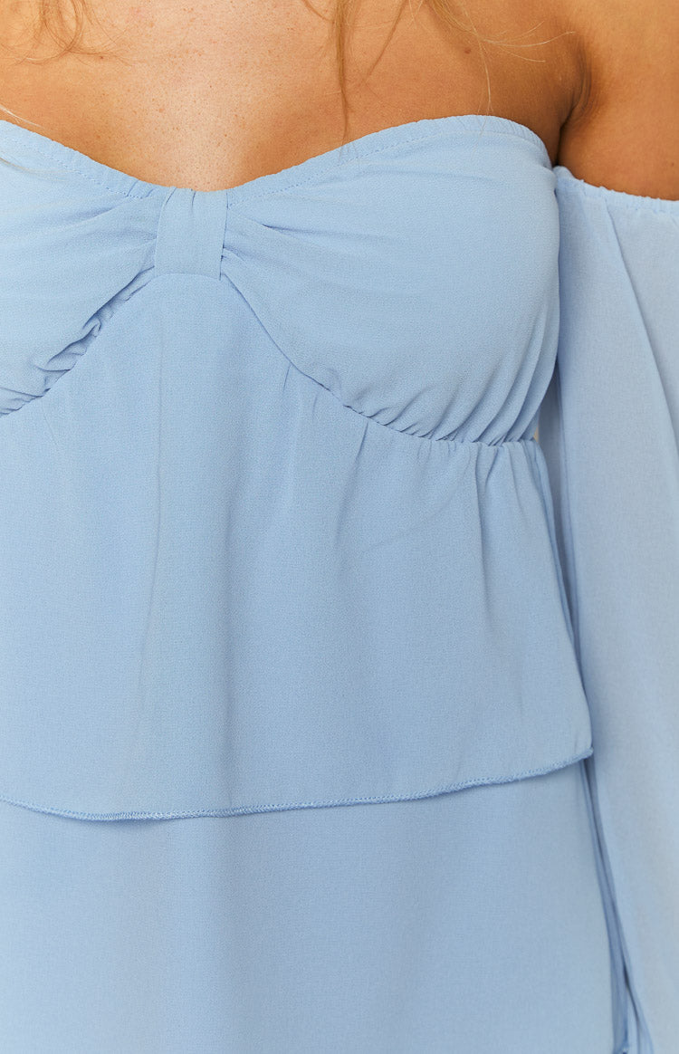 Close-up of the light blue off-shoulder mini dress bodice showing sweetheart neckline with bow detail and ruched waist