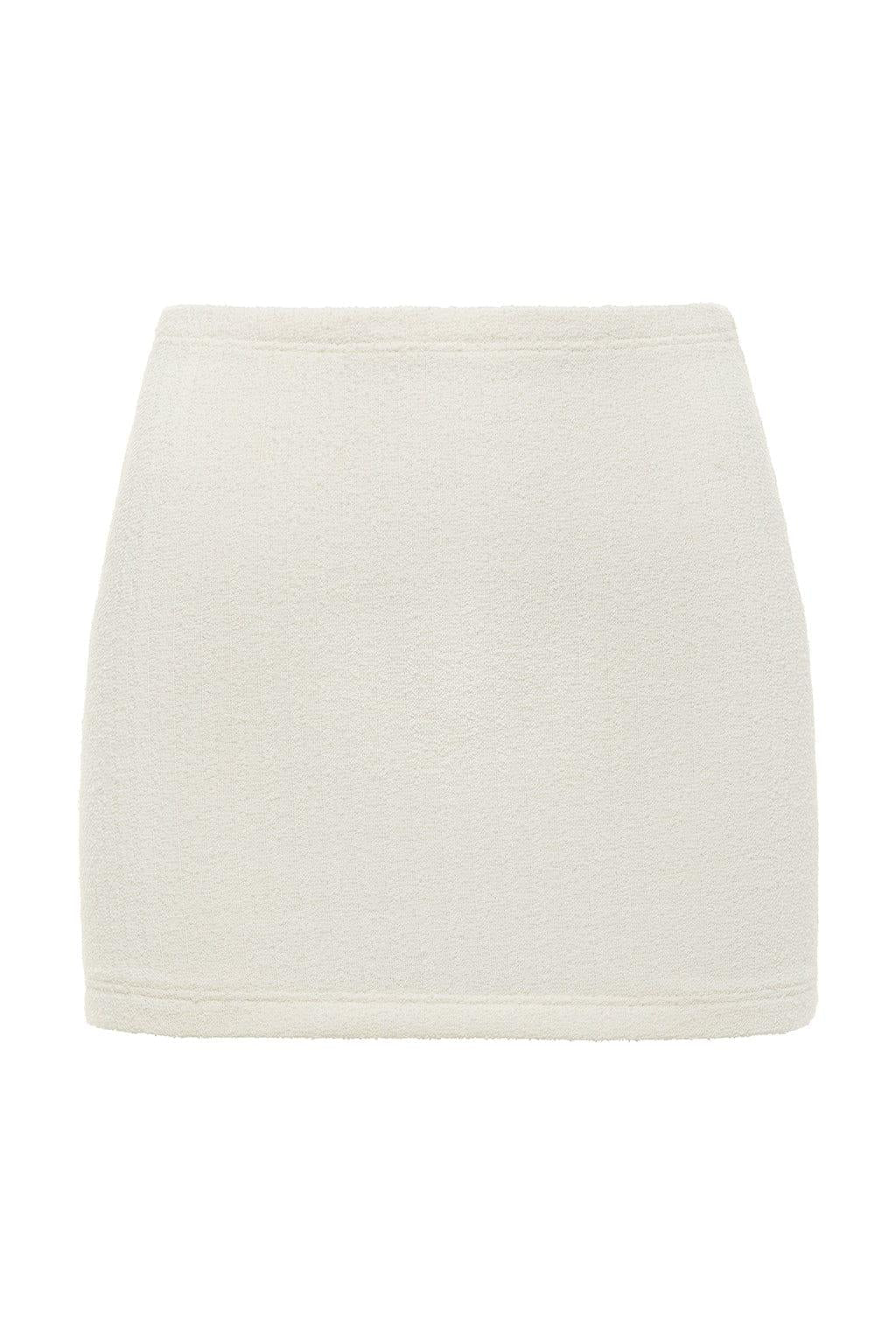 Cream-colored terry cloth micro skirt with ribbed texture and elastic waistband.