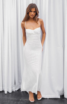 White maxi dress with a ruched sweetheart neckline, thin spaghetti straps, and a subtle textured pattern on the fabric