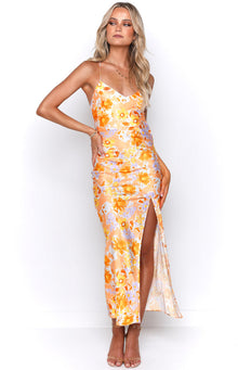 Rear view of an orange floral maxi dress with a low scoop back and criss-cross tie straps