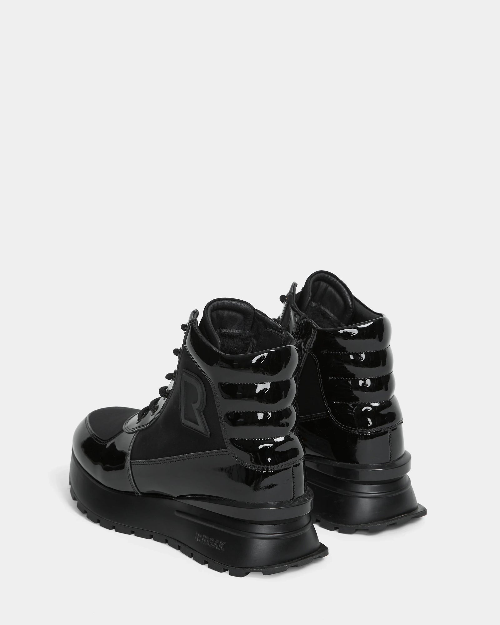 The Rudsak CHELSA - L224505 Black womens sneaker boots feature a waterproof zipper for easy wear—stylish, weather-resistant footwear for any occasion.
