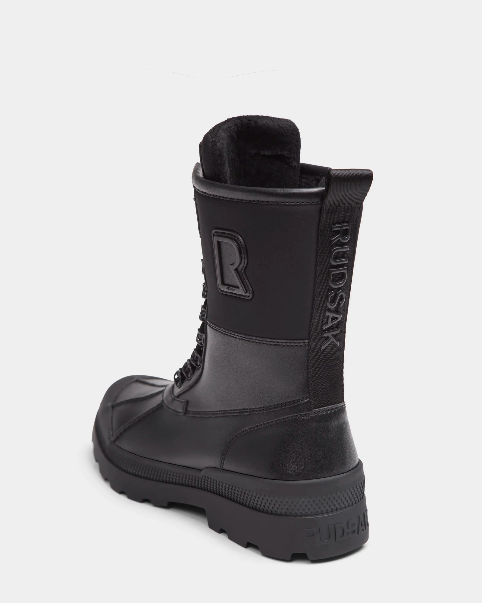 The DAMIEN - M222500 Black men’s winter boot by Rudsak features weather-treated leather, rugged sole, lace-up front, pull tab, insulation, embossed Rudsak branding on the heel and pull tab, and a large R logo on the side.