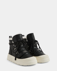 Rudsak’s ALEXEY L - L225518 Black high-top sneakers feature cozy wool lining, thick white rubber soles, black laces, and silver eyelets—a stylish winter boot photographed on a light gray background.