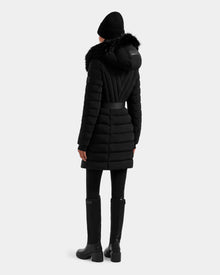 A person wearing the Rudsak ALISA M - L125586 Black quilted down parka stands with their back to the camera, set against a plain light background.