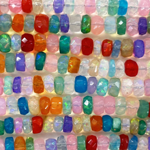 Close-up of colorful beads arranged in rows.