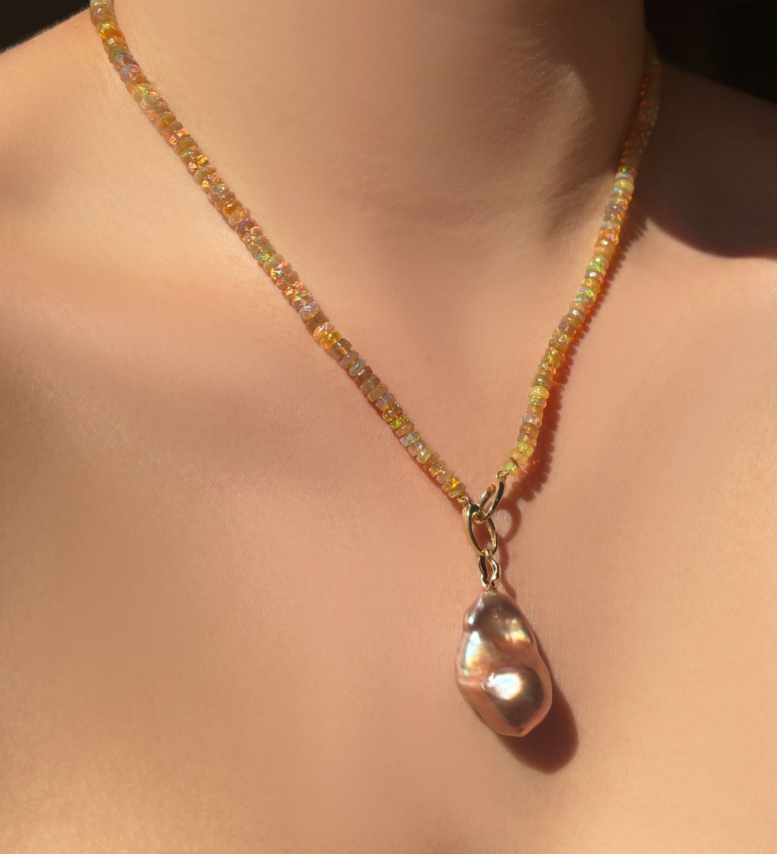 Golden Opal with Blush Baroque Pearl hanging from the neck.