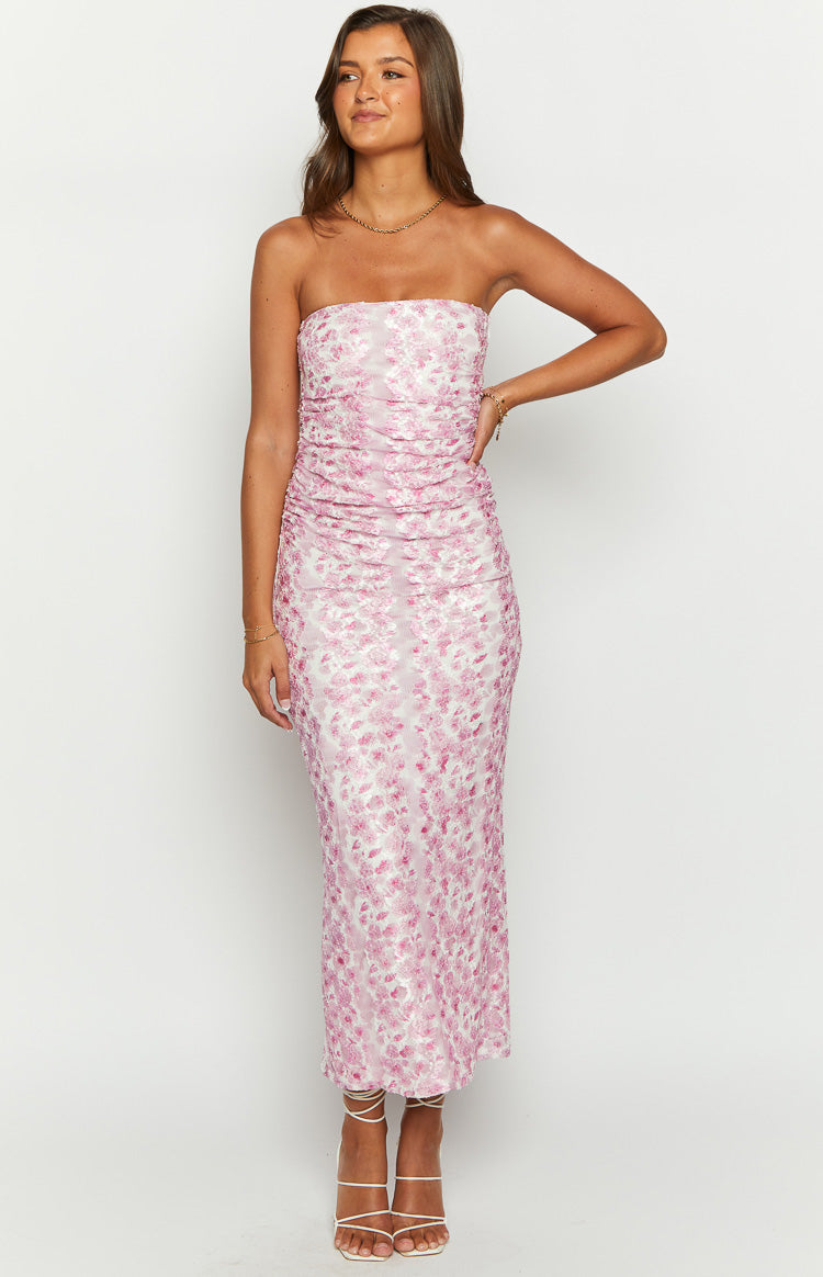Full length view of a pink floral print strapless maxi dress with a fitted silhouette and ruched detailing