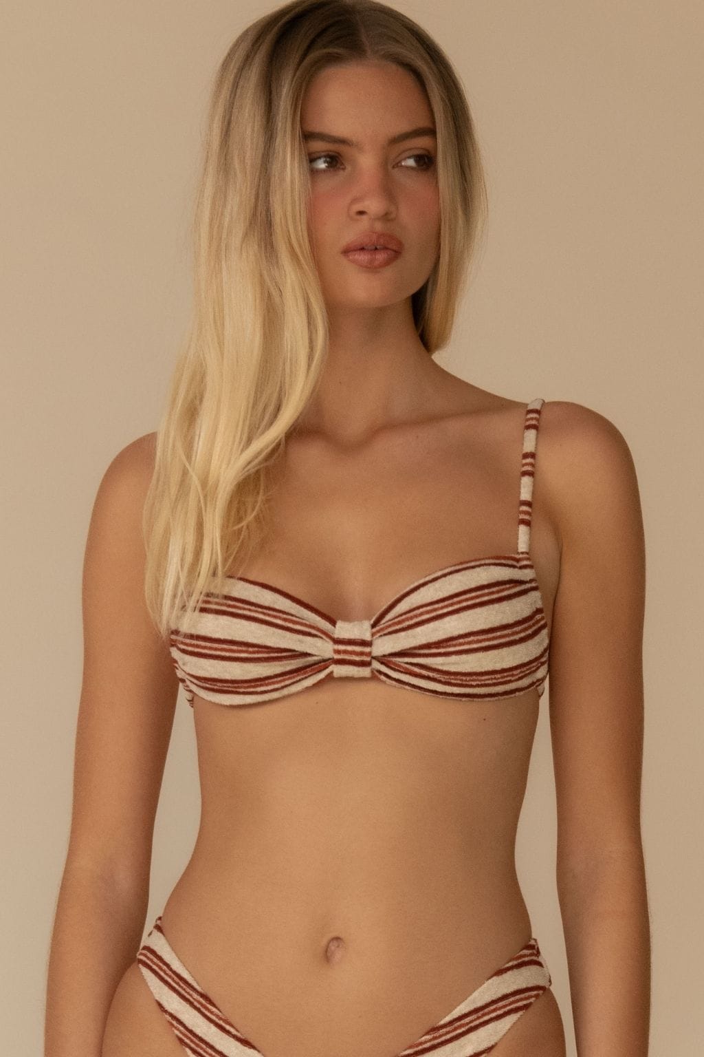 Cream and burgundy striped bikini top with bow detail and adjustable shoulder straps.