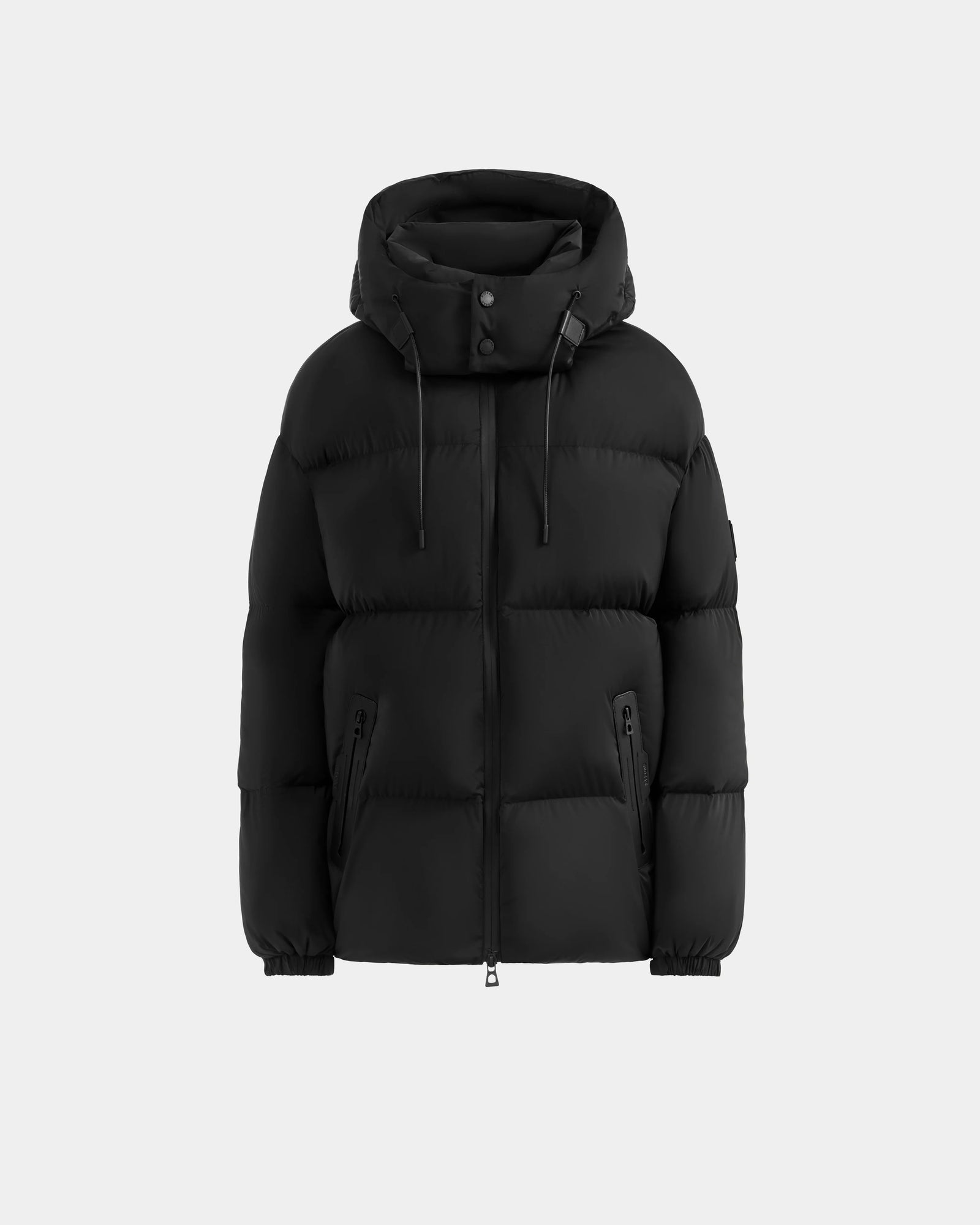 The KARLEE M - 8125681 Black women's down puffer jacket by Rudsak features a hood, front zipper, snap buttons, two zippered side pockets, and elastic cuffs for winter warmth, shown on a light gray background.