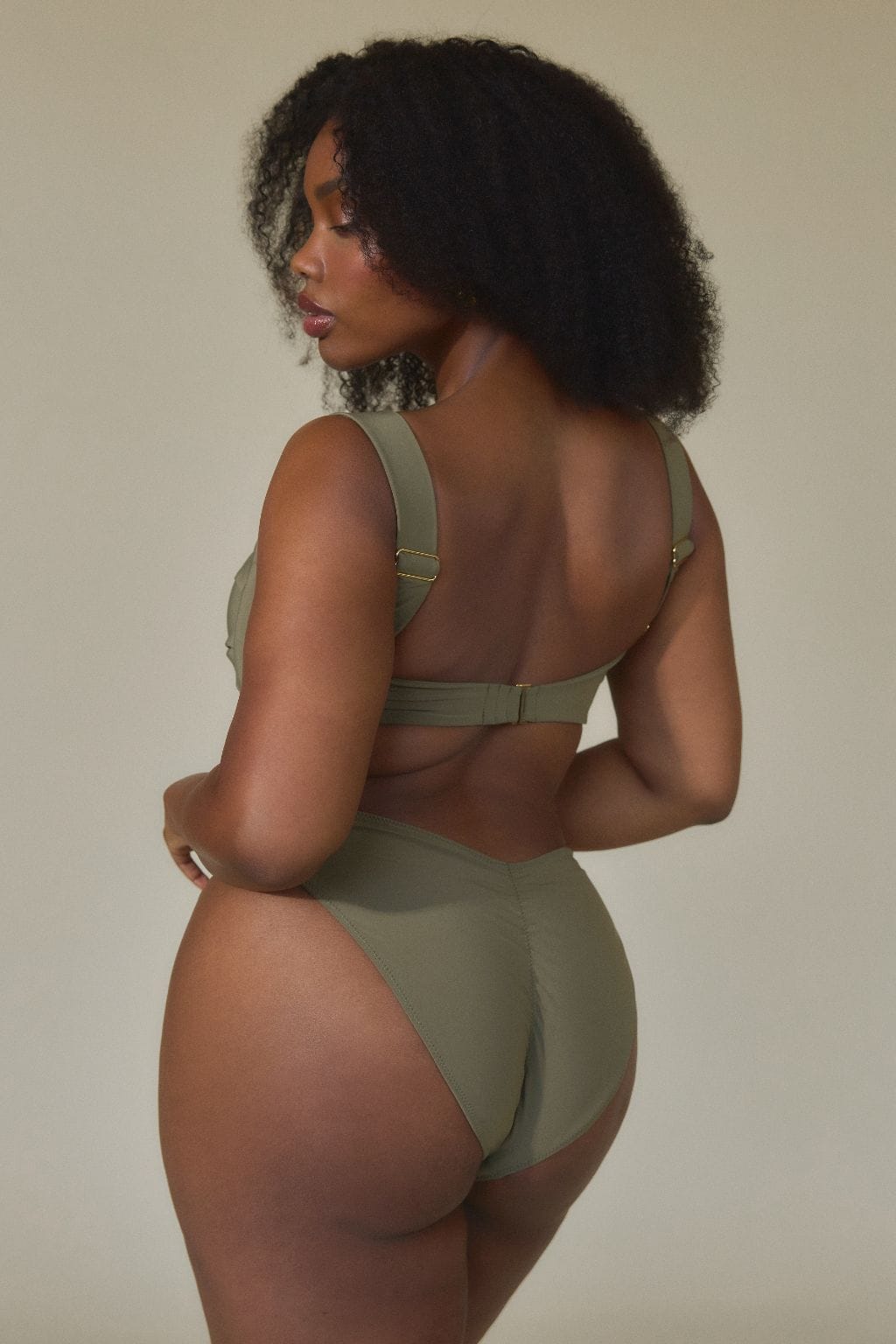 Khaki bikini top with adjustable straps and back closure, shown from behind on model.