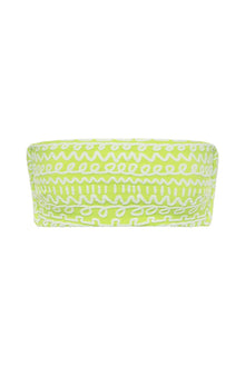 Lime green bikini top with white geometric and abstract patterns throughout.