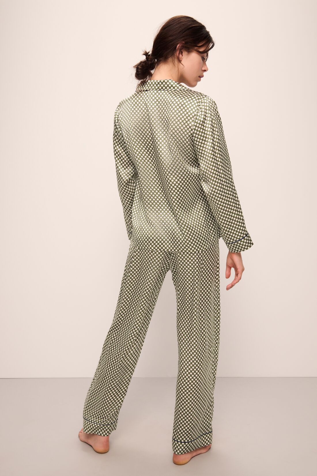 Model is wearing Inez Washable Silk Printed Long PJ Set in Geo Sphere Moss/Navy.