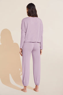 Model wears Gisele TENCEL Modal Slouchy PJ Set in lavender/ivory.