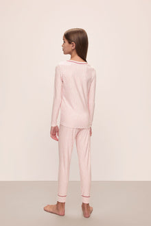 Model wears Kids Printed TENCEL Modal Unisex Long PJ Set in Duo Stripe Haute Red/Haute Red.