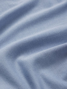 Model wears Kids TENCEL Modal Unisex Long PJ Set in Wedgewood Blue/Ivory.