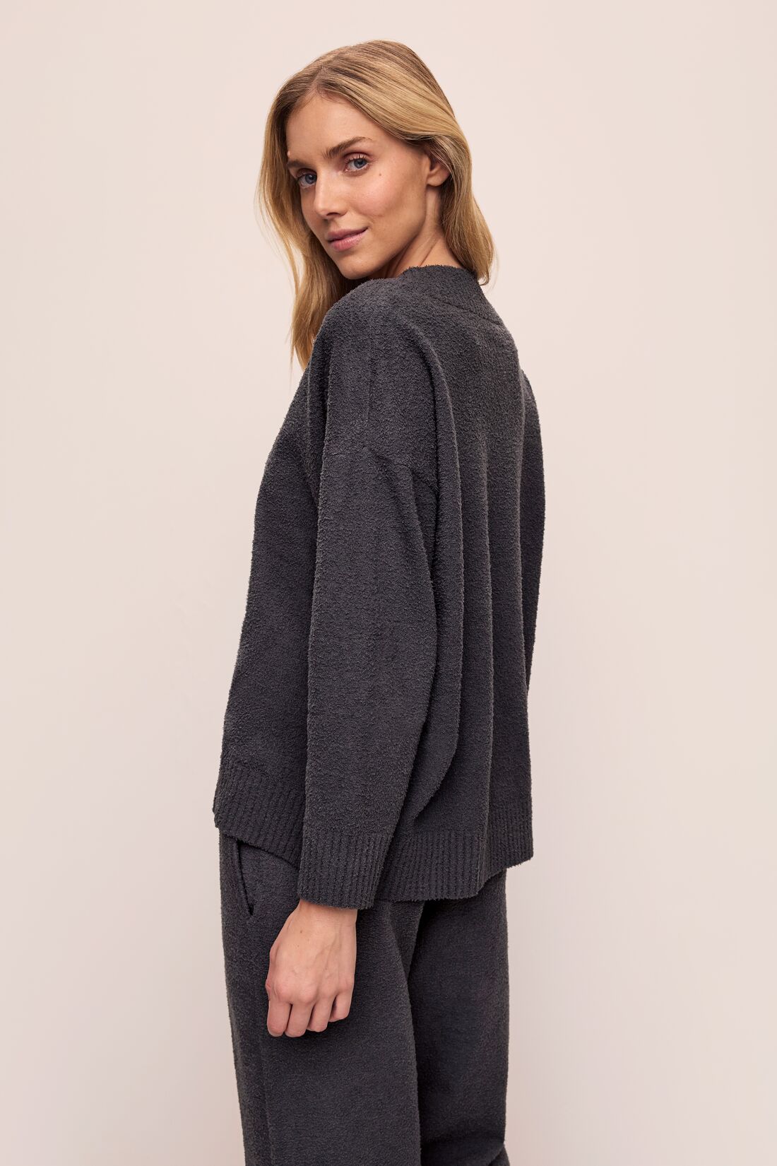 Model wears Recycled Boucle Boyfriend Oversized V-Neck Sweater in Graphite.