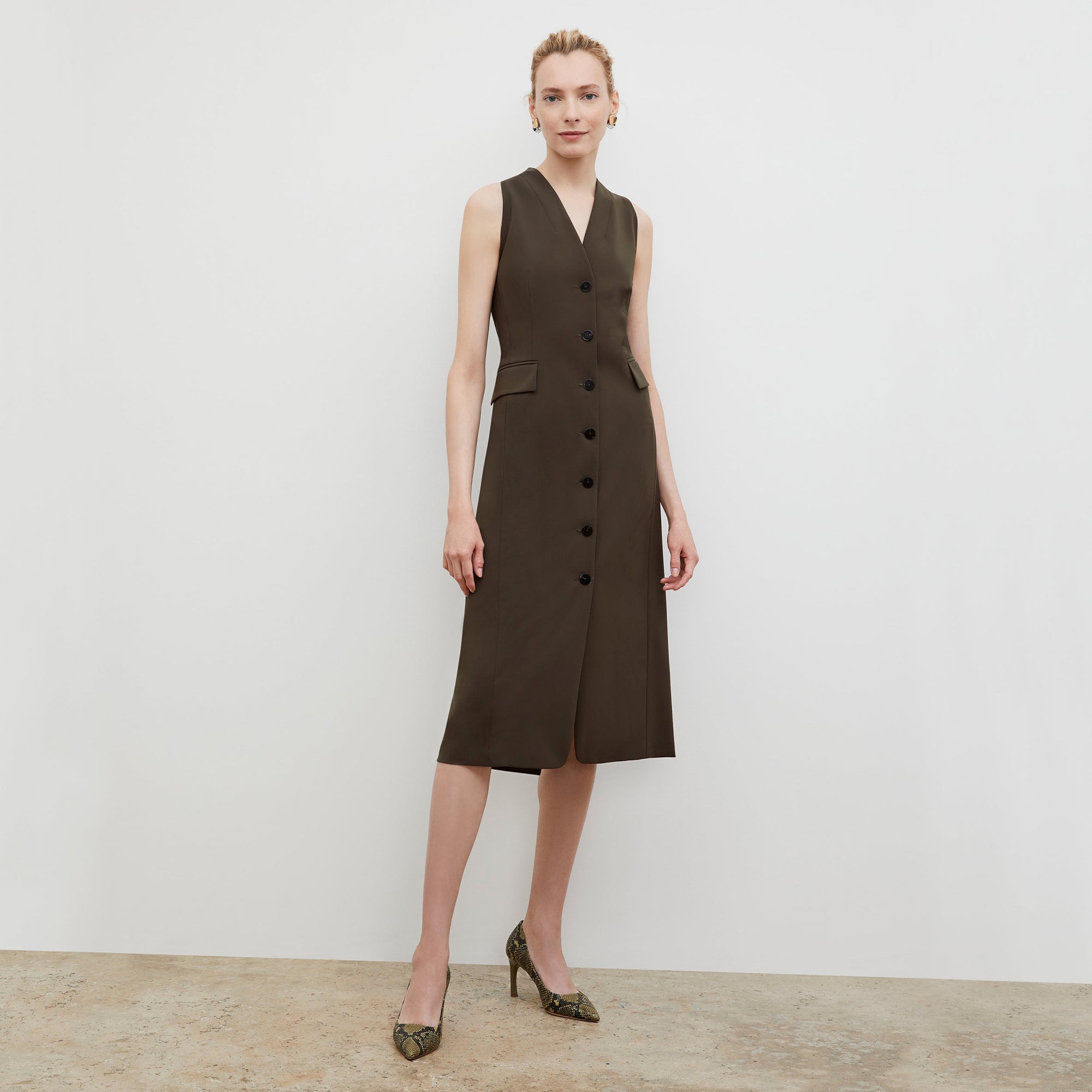 Front image of a woman wearing the Cassandra dress in origamitech in olive | Exclude