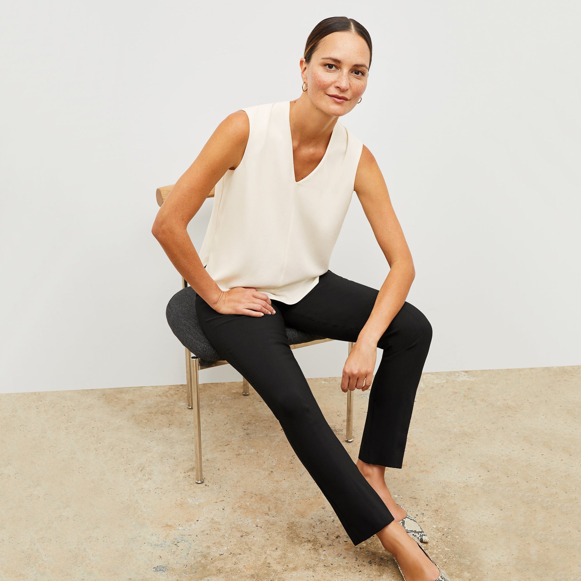 Front image of a woman standing wearing the Foster Pant—Everstretch in Black | Exclude
