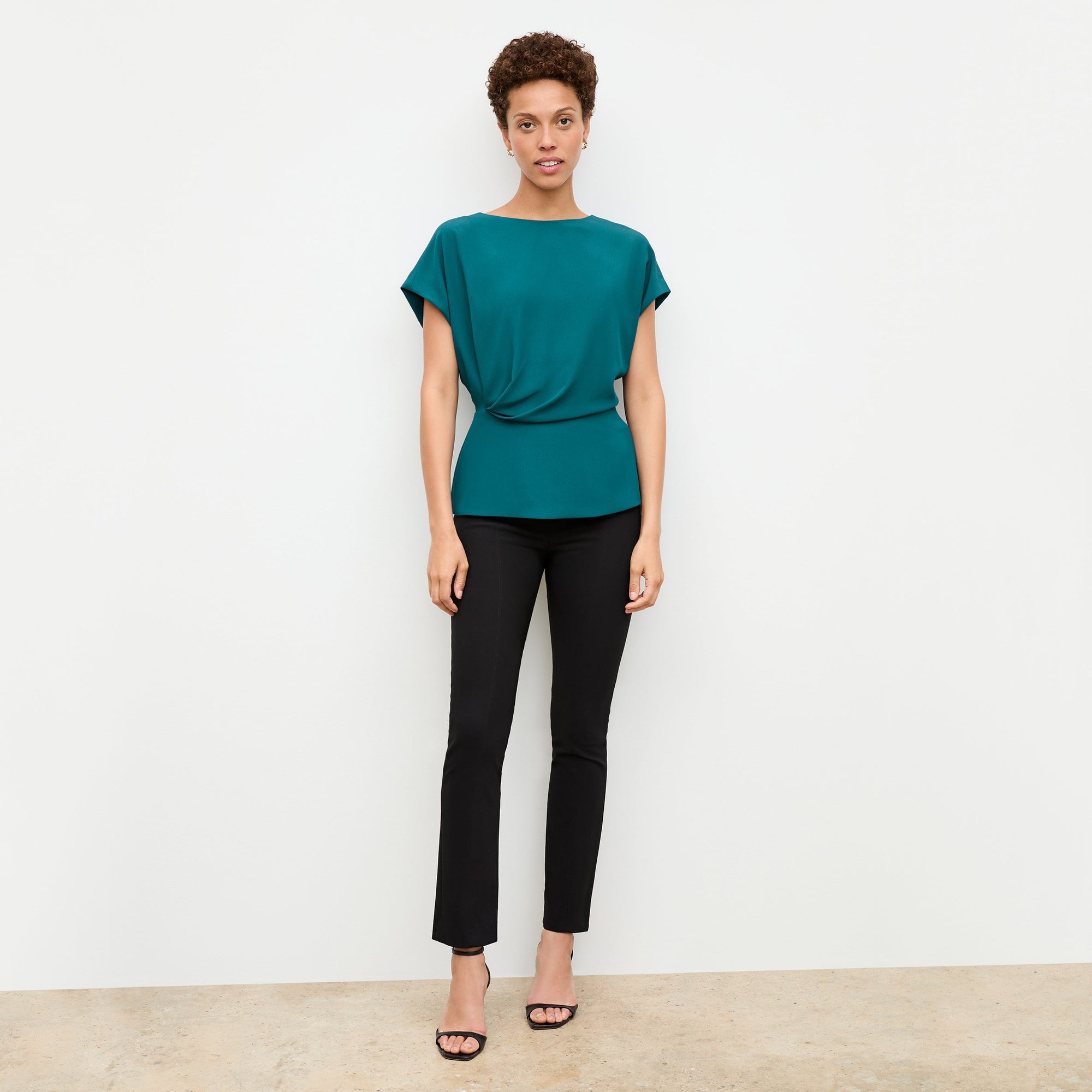 Front image of a woman standing wearing the Foster Pant—Everstretch in Black | Exclude