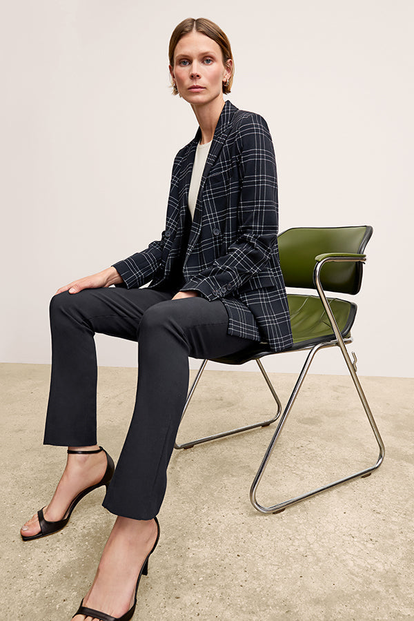 Front image of a woman standing wearing the Foster Pant—Everstretch in Black | Exclude