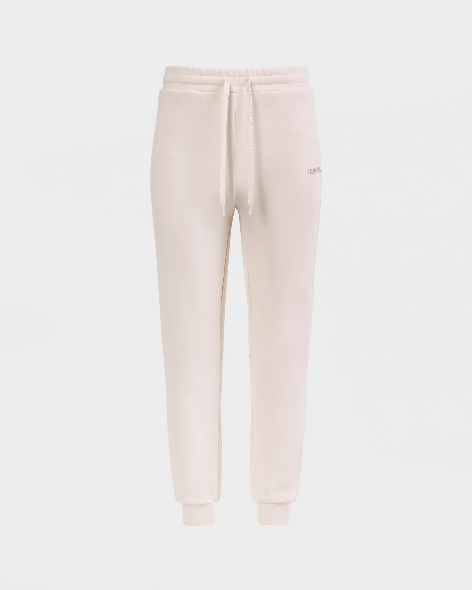 The Rudsak MAXTON - U525007 Vanilla M jogger sweatpants feature a beige cotton blend, elastic waistband with drawstring, side pockets, and cuffed ankles for everyday comfort, shown against a white background.