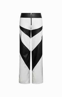 Rear view of white and black PU pants with a chevron pattern and exposed black back zipper