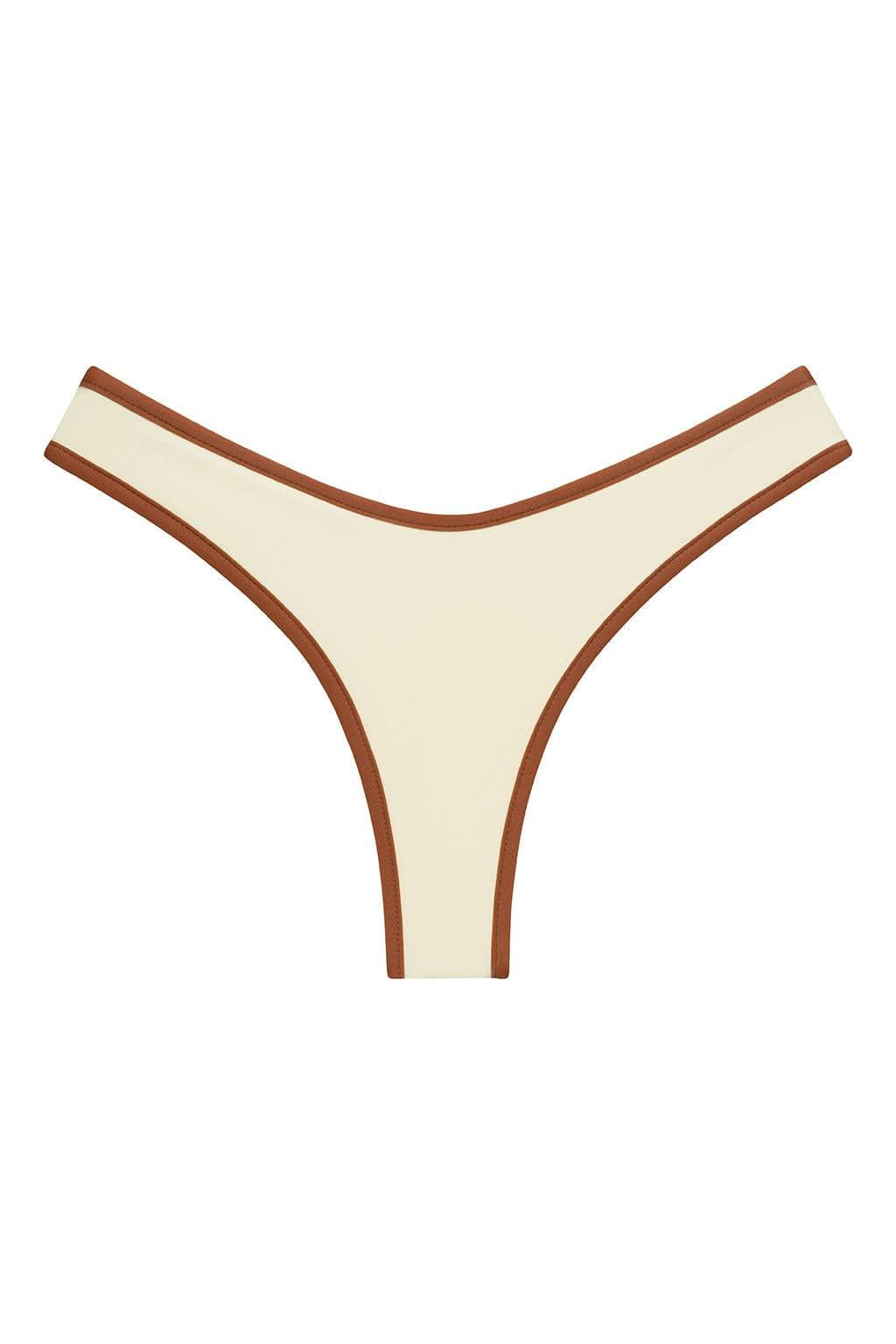 Cream bikini bottom with terracotta binding trim along the edges and waistband.