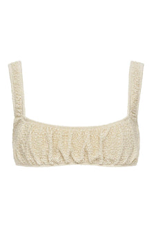 Oat-colored textured sport top with wide shoulder straps and ruched front detail.