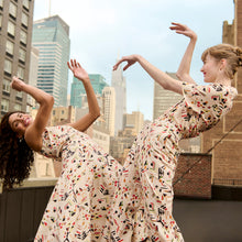 front image of a woman wearing the oona dress in rhythm print