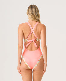 Pink one-piece swimsuit with open back and bow detail on a white background