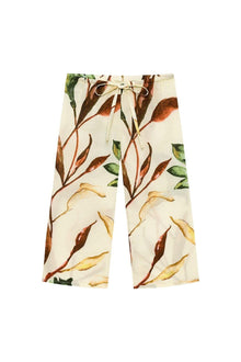 Wide-leg pants with floral botanical print in brown, rust, and green on cream background, featuring drawstring waist.