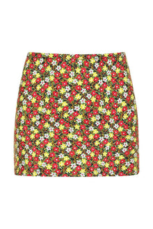 Mini skirt with red, yellow, and white floral print on dark background.