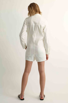Woman wearing a white linen jumpsuit