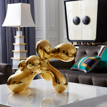 giant brass orb op art with aspen daybed
