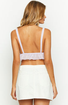 Close-up of the right front pocket with a silver rivet, belt loop, and waistband of a white denim mini skirt