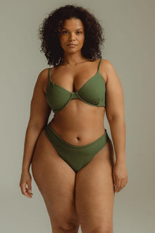 Olive green bikini top with thin shoulder straps and textured fabric, displayed on a model.