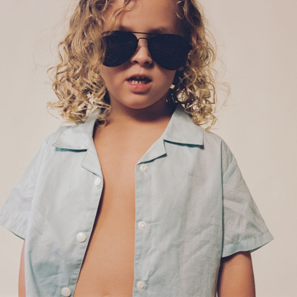 Light blue short-sleeve button-down shirt with dark trim on collar and cuffs.