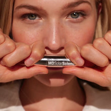lipstick tubes on a green fir background