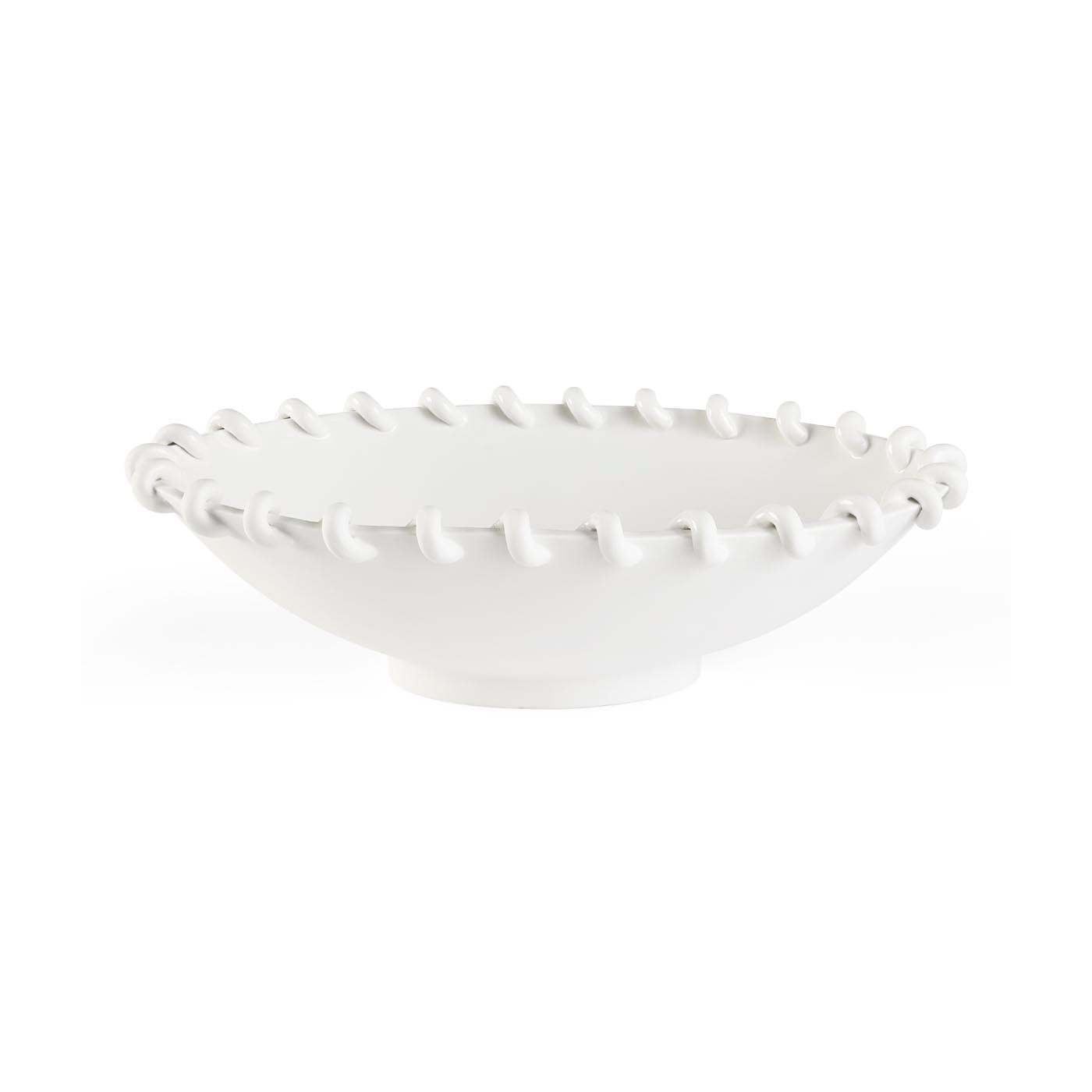 White ceramic bowl with textured rim on a white background